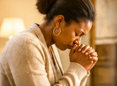 Woman praying with her hands folded